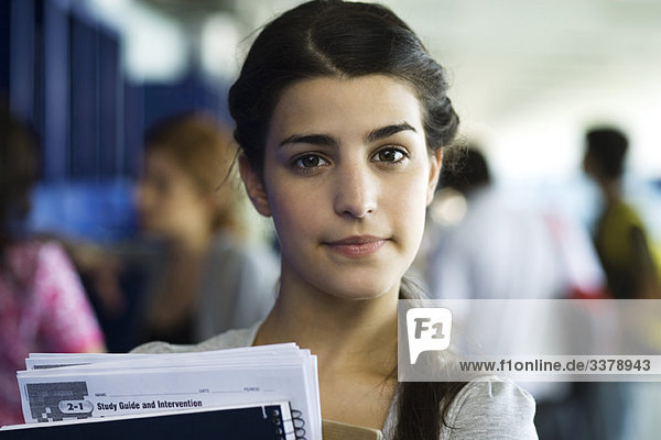 Female high school student holding books  portrait