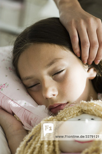Girl sleeping with doll