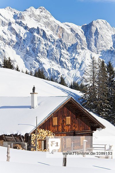 Snow-covered mountain cabin mountains in the background Mühlbach am Hochkönig Austria