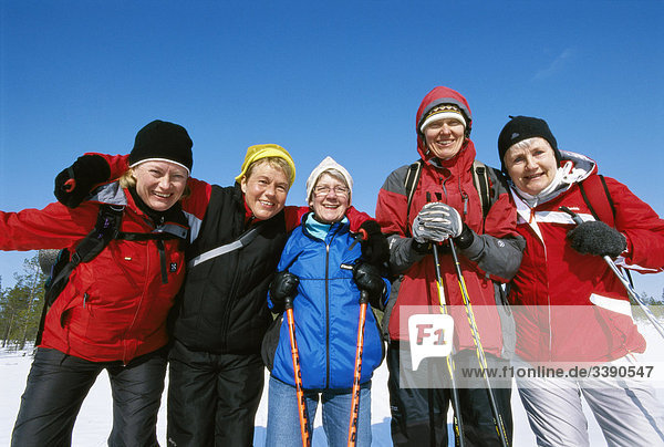 Fünf glücklich Frauen auf Skiern