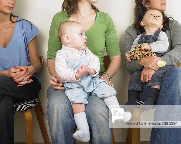 Women and babies in waiting room