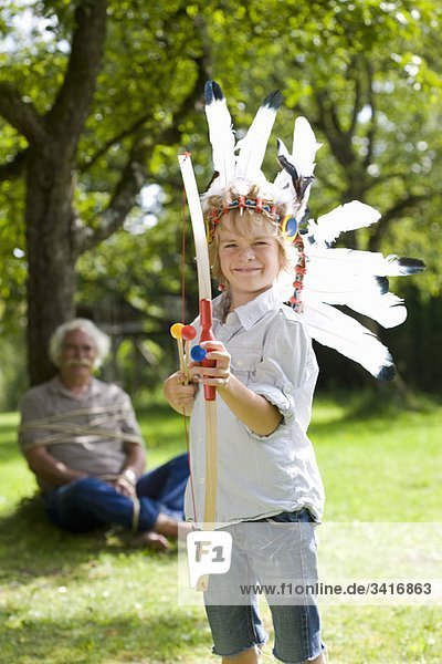 Disguised boy with toy bow and arrows