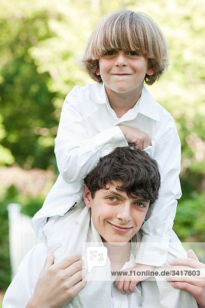 Young boy on shoulders of older boy
