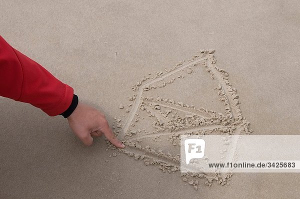 Germany  Schleswig Holstein  Amrum  Person drawing house in sand