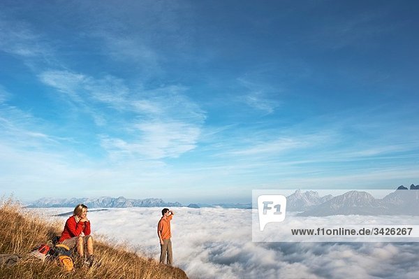 Austria  Steiermark  Reiteralm  Hikers admiring view over clouds