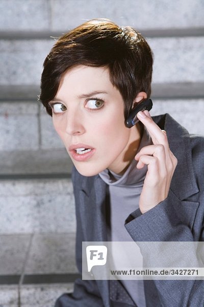 Business woman wearing bluetooth headset  portrait  close-up