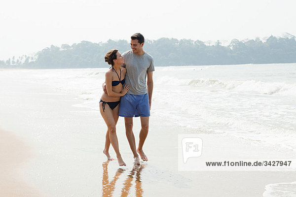 Couple walking by the ocean
