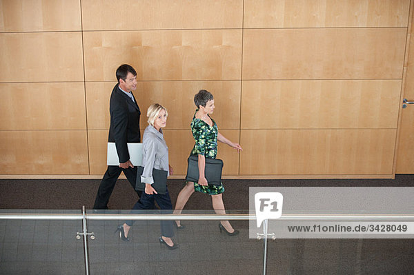 Businesspeople walking through corridor