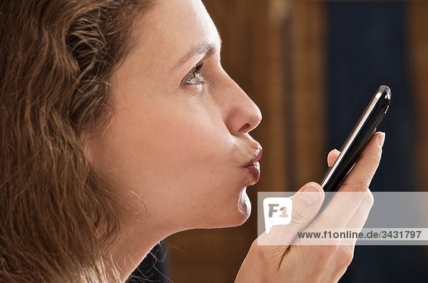 woman sending a kiss by telephone