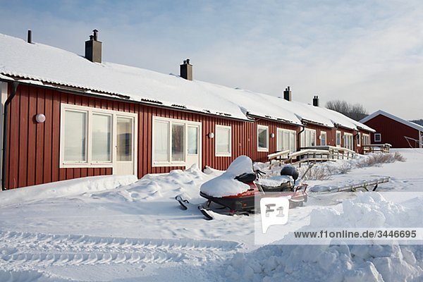 Scandinavia  Sweden  Harjedalen  Vemdalen  Snowmobile in front of house