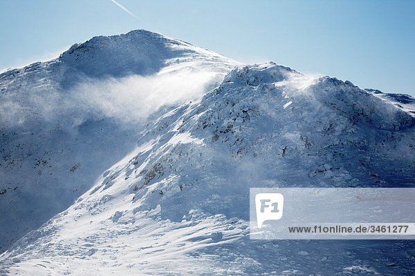 Strong winds cause snow to blow off the summit of Mount John Quincy Adams in the Presidential Range during the winter months in the White Mountains  New Hampshire USA