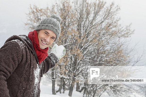 Young man about to throw a snowball