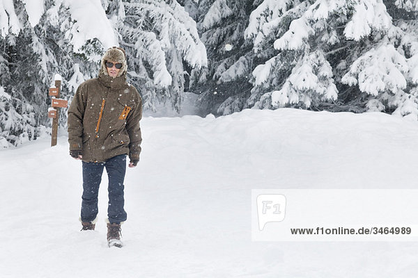 Young man walking in snow