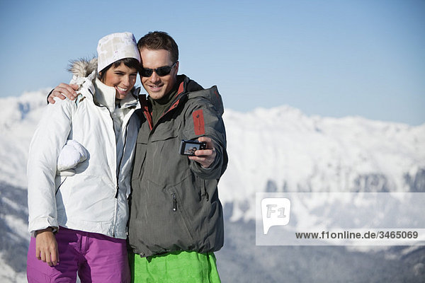Junges Paar in Skibekleidung beim Selbstportrait