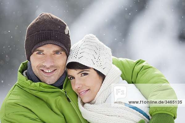 Young couple in winter clothes embracing