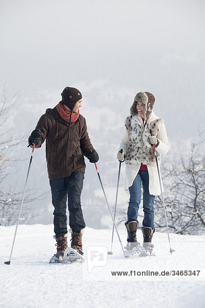 Young couple snowshoeing