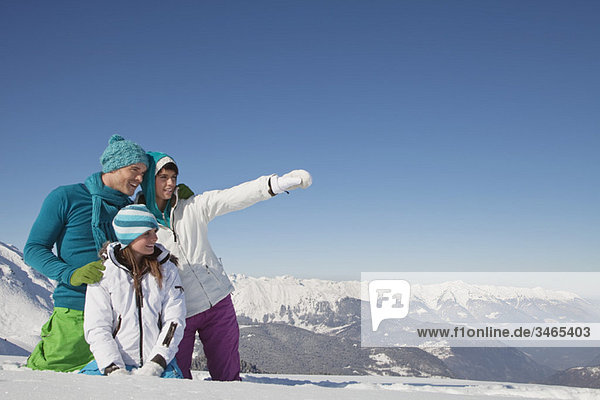 Couple and daughter in ski wear  looking away