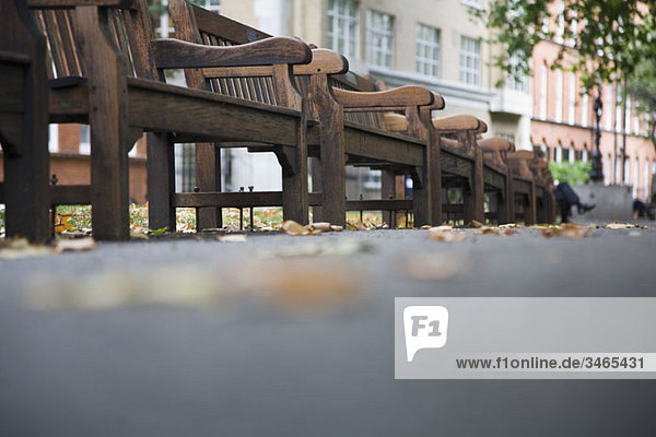 Low view of wooden benches in a park