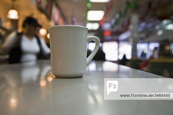 A coffee cup on a diner counter