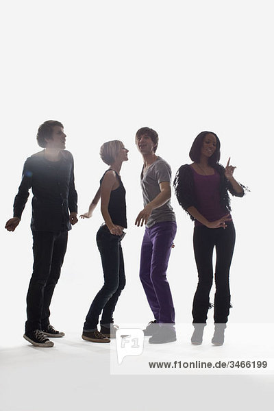Vier junge Leute tanzen  Studioaufnahme  weißer Hintergrund  hinterleuchtet