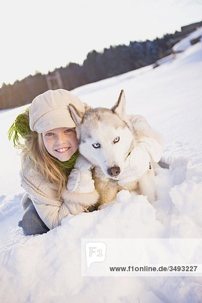 Girl embracing siberian husky