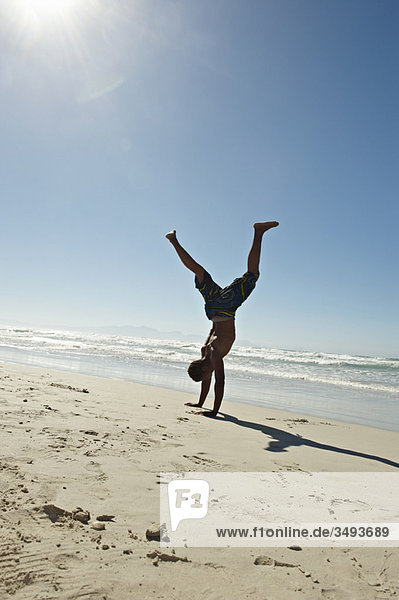 Young man doing hand stands