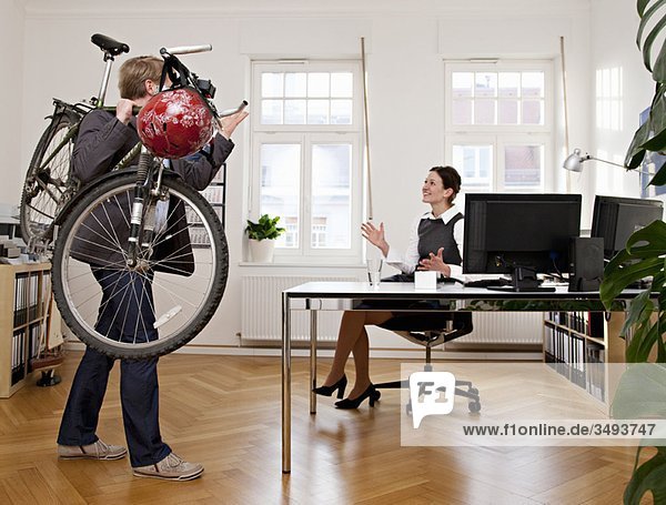 Businesspeople in office with bicycle