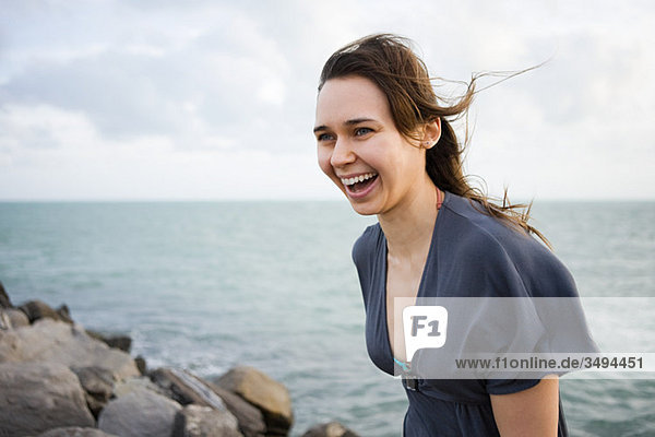 Happy young woman by the sea