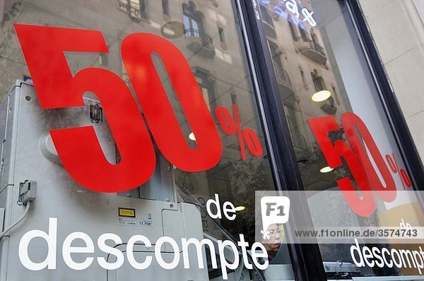 Woman in a shop with 50% discount sign  Barcelona. Catalonia  Spain