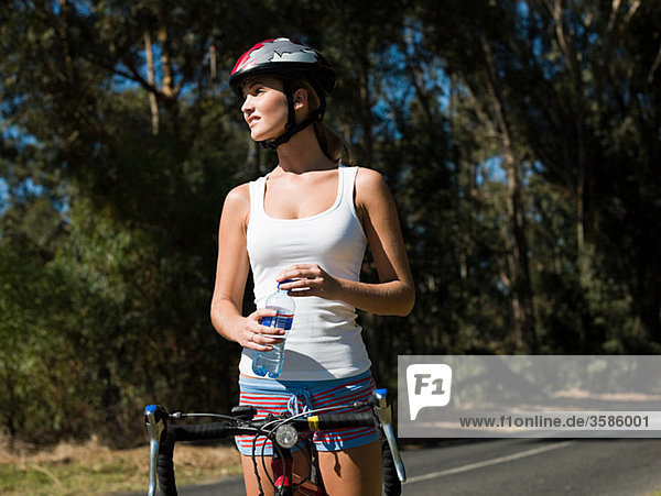 Young woman cycling on road