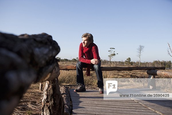 Man relaxing on wooden bench