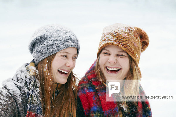 Two happy young women in snow