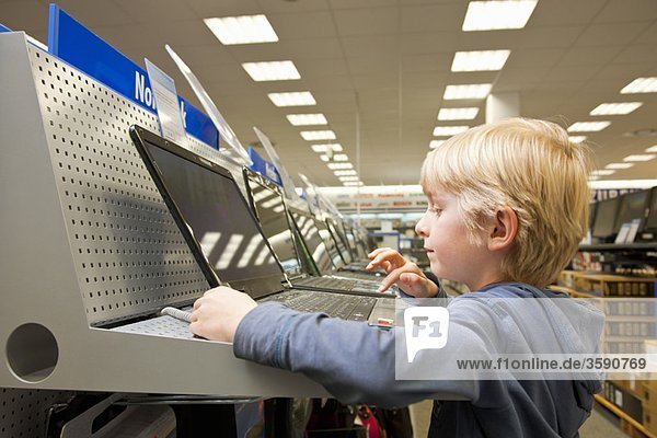 Little boy is testing a laptop computer