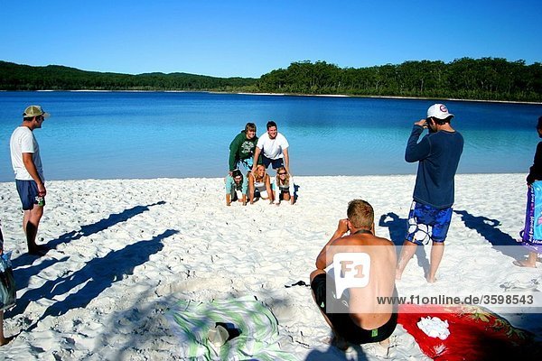 Backpackers enjoy the sun on Lake McKenzie white sand beaches  Fraser Island  Queensland  Australia