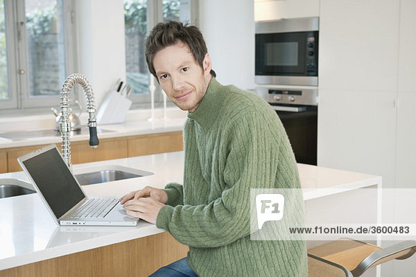 Portrait of a man working on a laptop