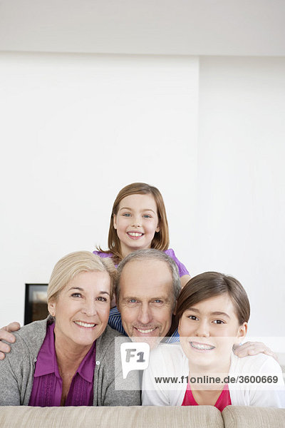 Couple smiling with their granddaughters