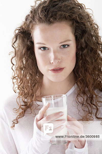 Portrait of a woman holding a glass of milk