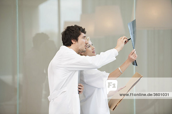 Doctors examining an x-ray report