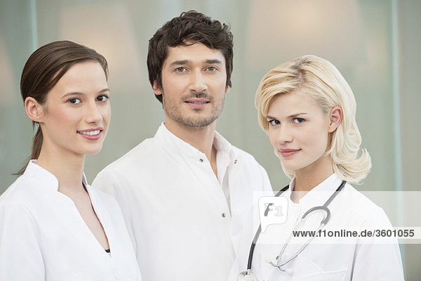 Male doctor standing with two female doctors