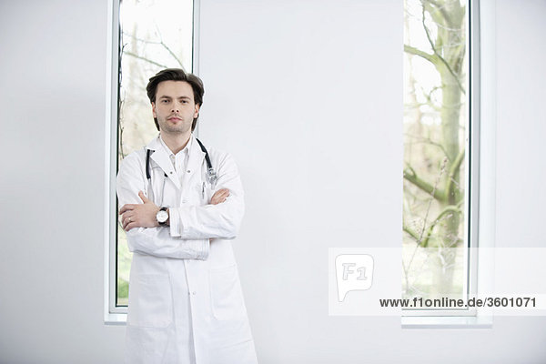 Portrait of a doctor standing with his arms crossed