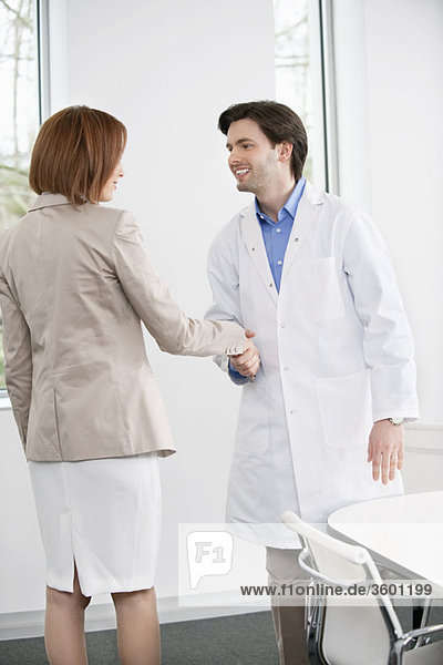 Doctor shaking hand with a woman