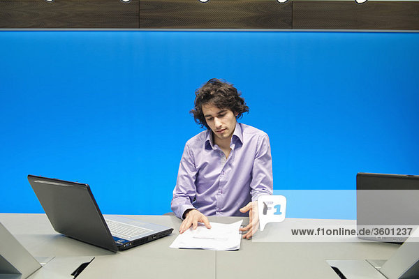 Businessman doing paperwork in a conference room