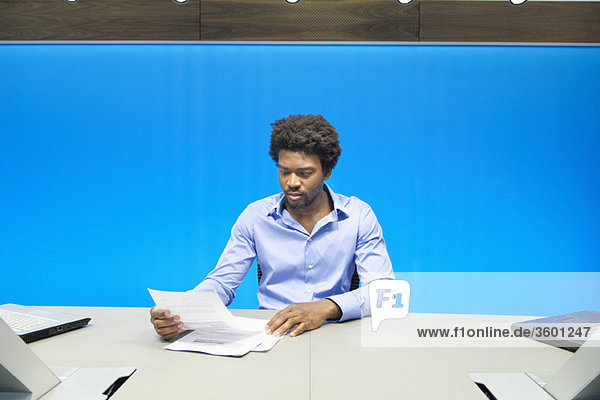 Businessman reading documents in a conference room