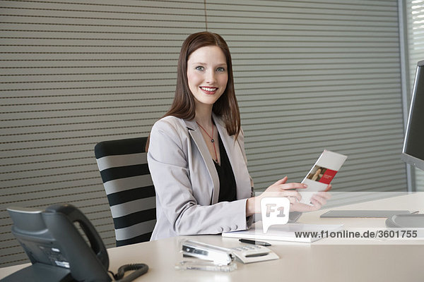 Businesswoman doing paperwork in an office