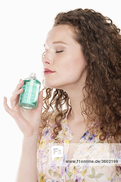Woman smelling aromatherapy oil