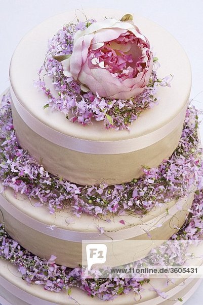 Three-tiered cream cake with spring flowers