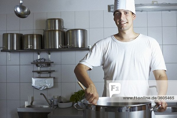 Chef stirring a pan on range