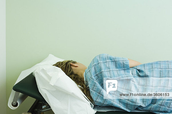 Female patient lying on side on examination table