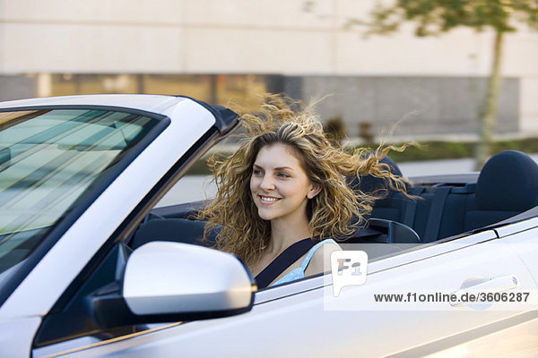 Young woman driving convertible