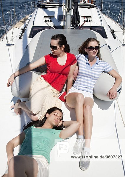 Three girls sitting on yacht